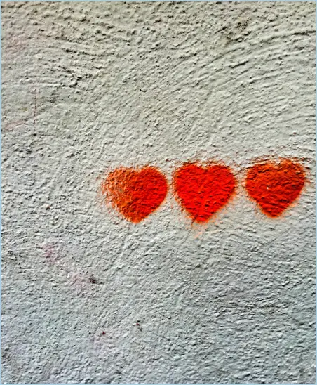 wall graffiti of three red hearts