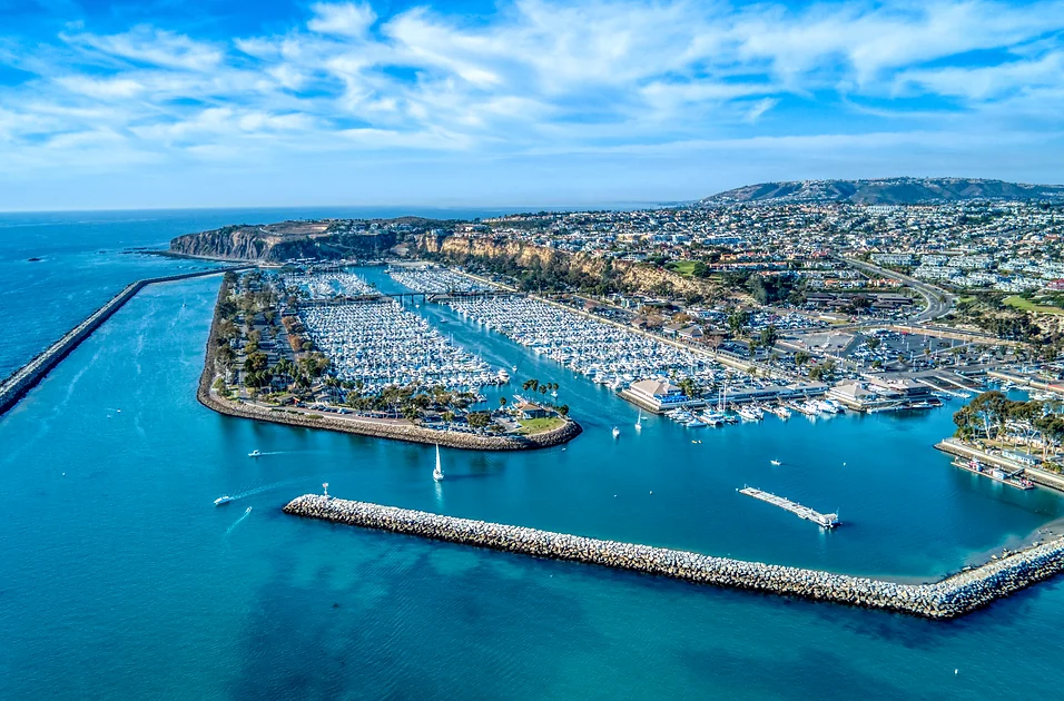Aerial view of San Juan Capistrano pier and the ocean with bright blue skies