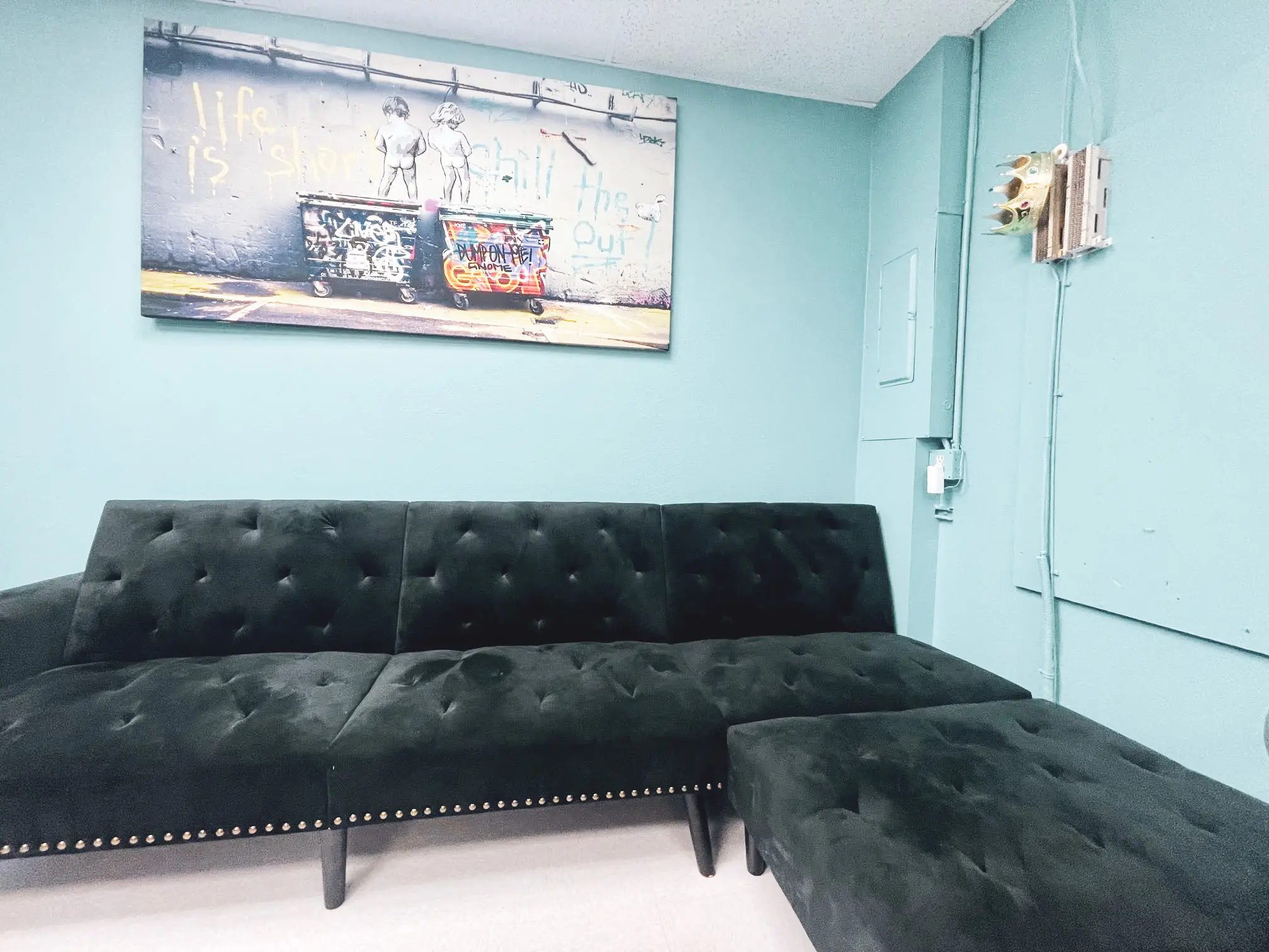 Mental Health Outpatient living room. There are 2 couches and artwork hanging on the wall