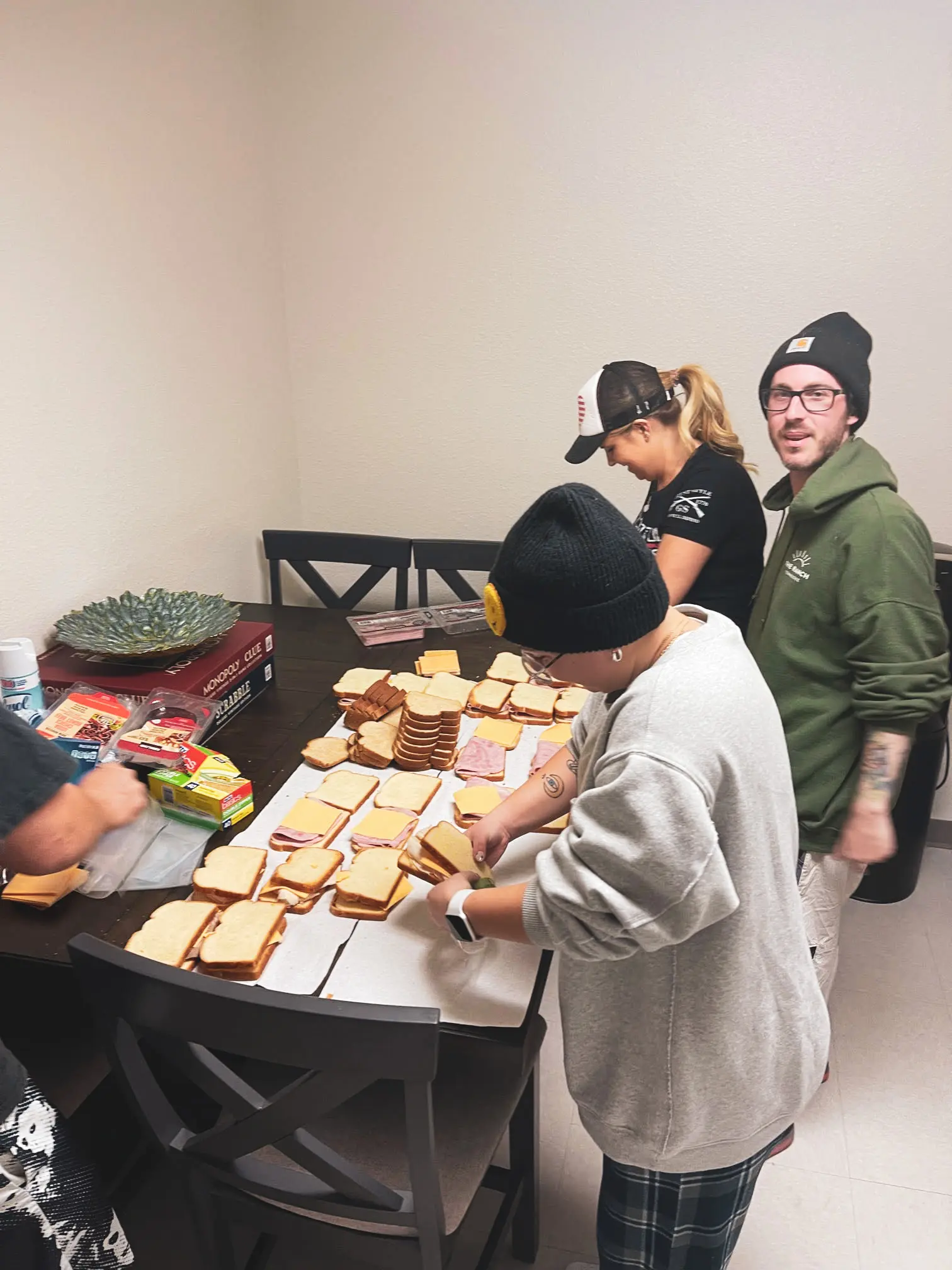 Mental health outpatient volunteer work. Volunteers are making sandwiches for the homeless