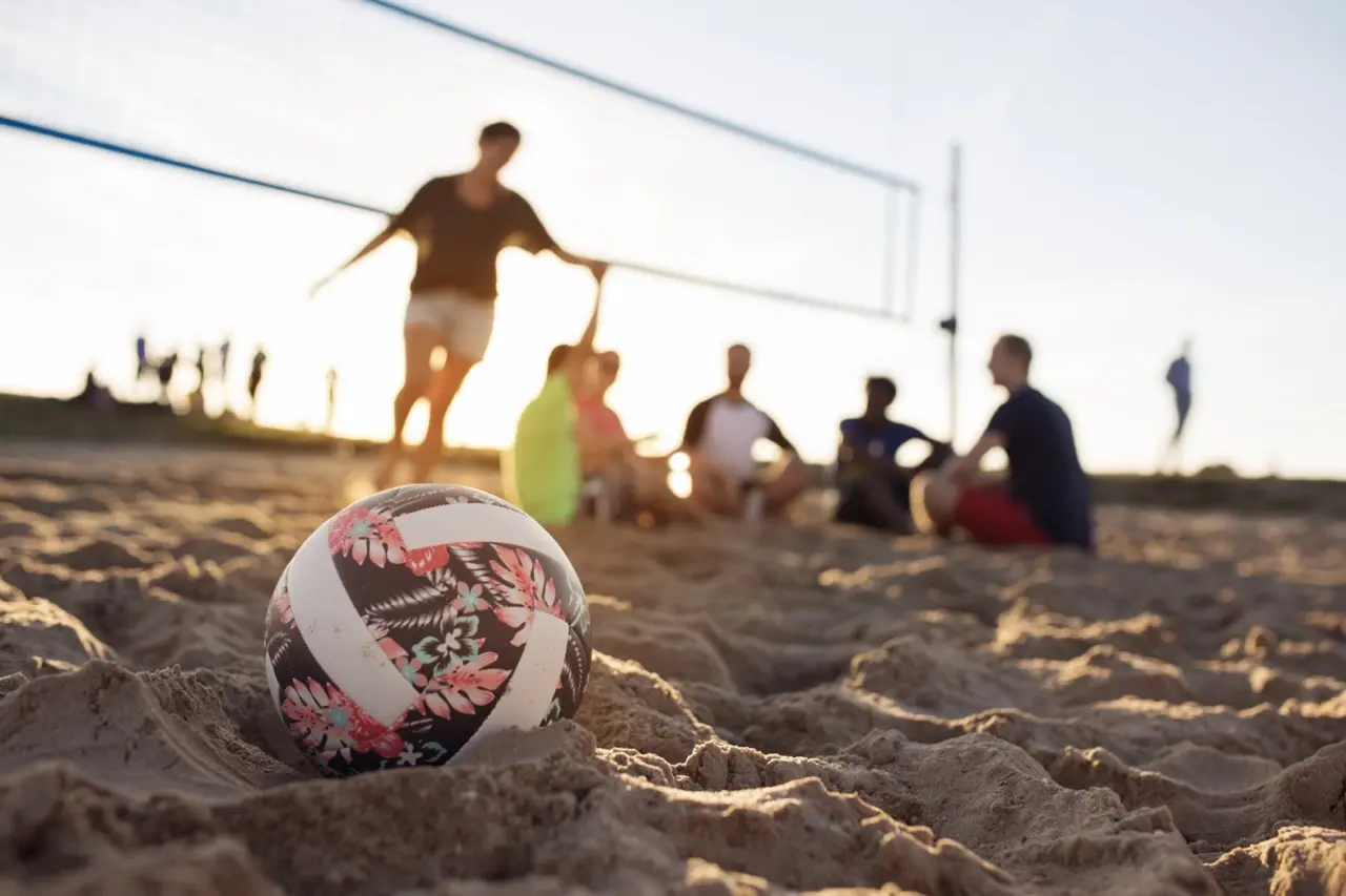 Friends playing beach volleyball