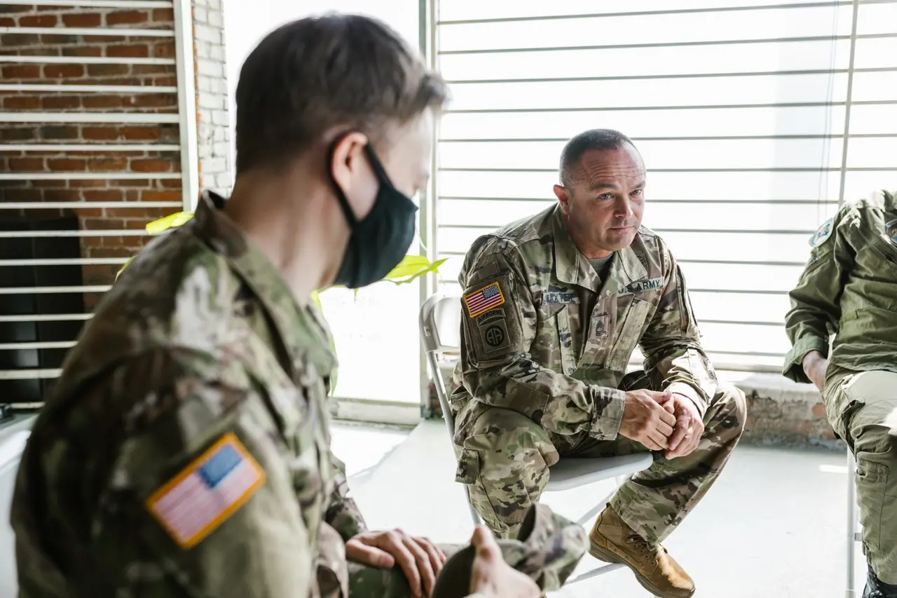 Group therapy session PTSD treatment for veterans. Shown in the picture are two Caucasian men in military uniforms